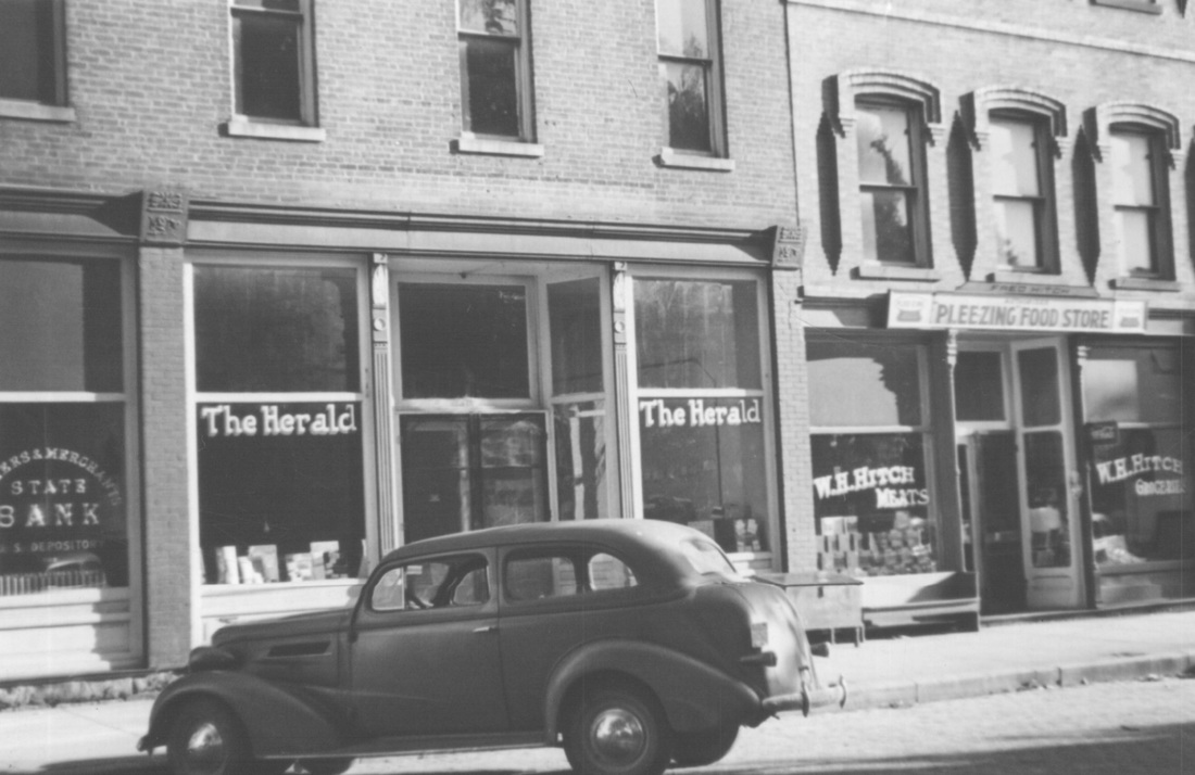 Herald Newspaper, Hitch's Grocery, and pool room. South side of Main St. 1940's.