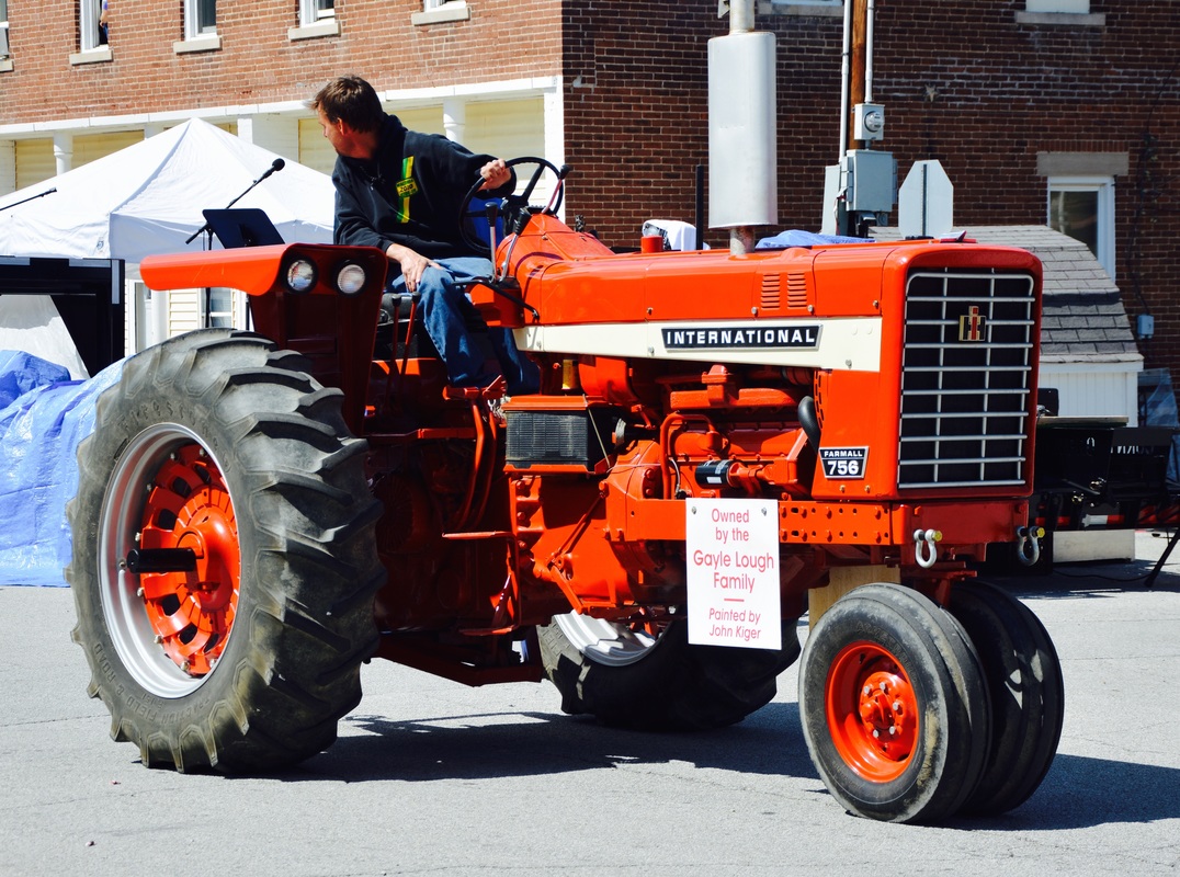 man on red tractor