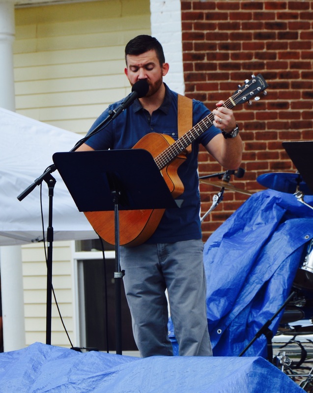 man singing on stage