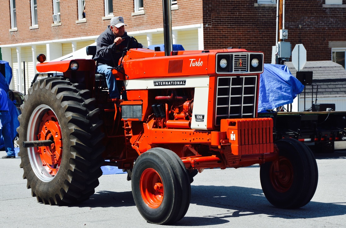 man on red tractor