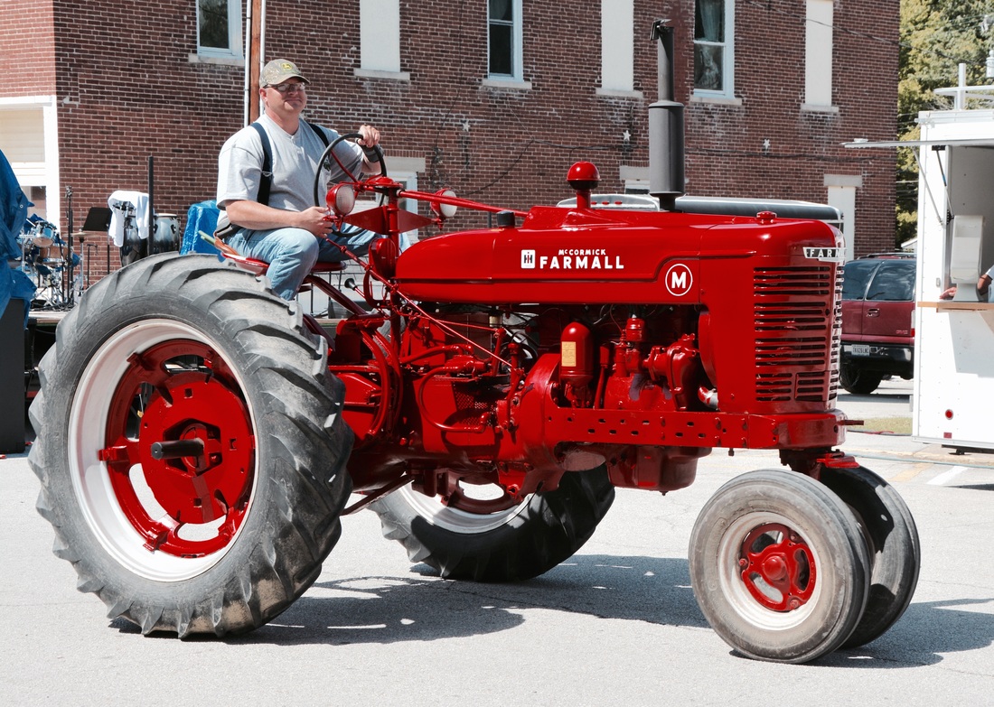 man on red tractor