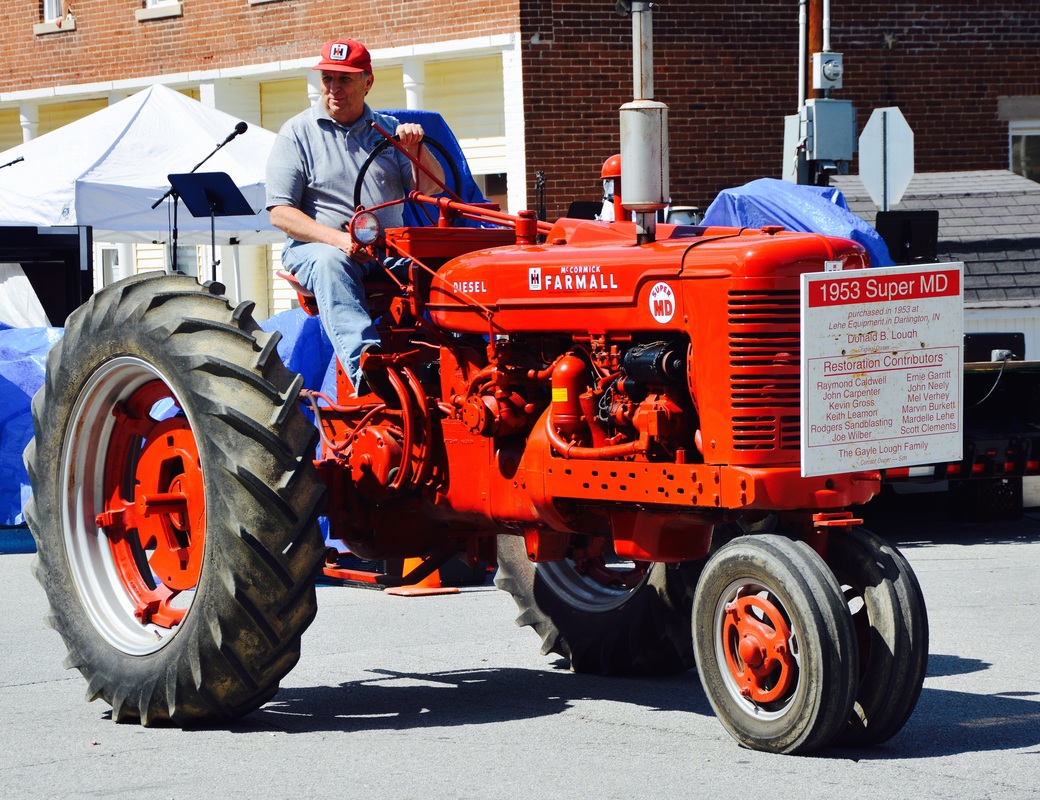 man on red tractor