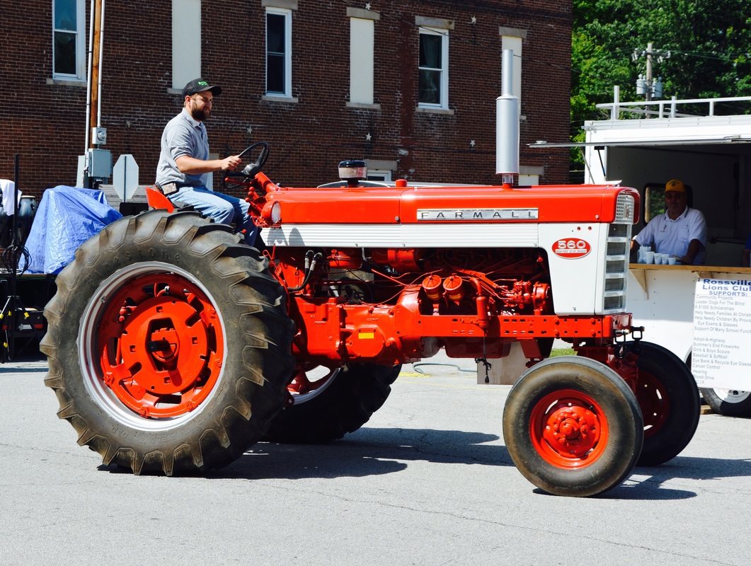 man on red tractor