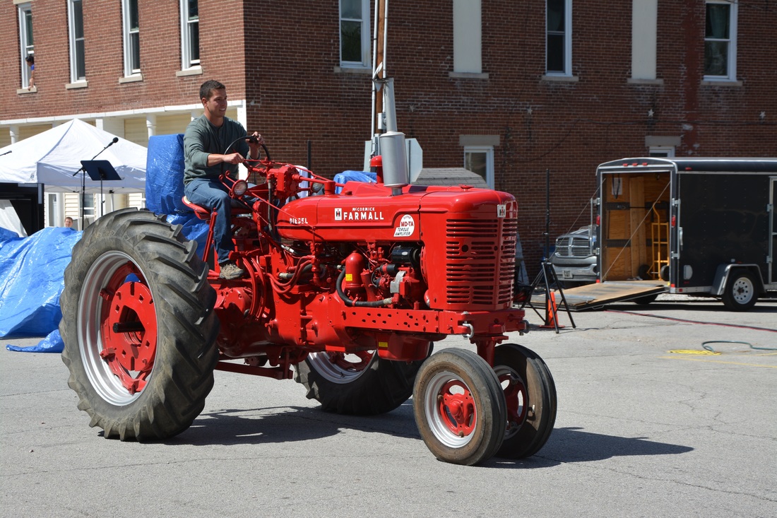man on red tractor