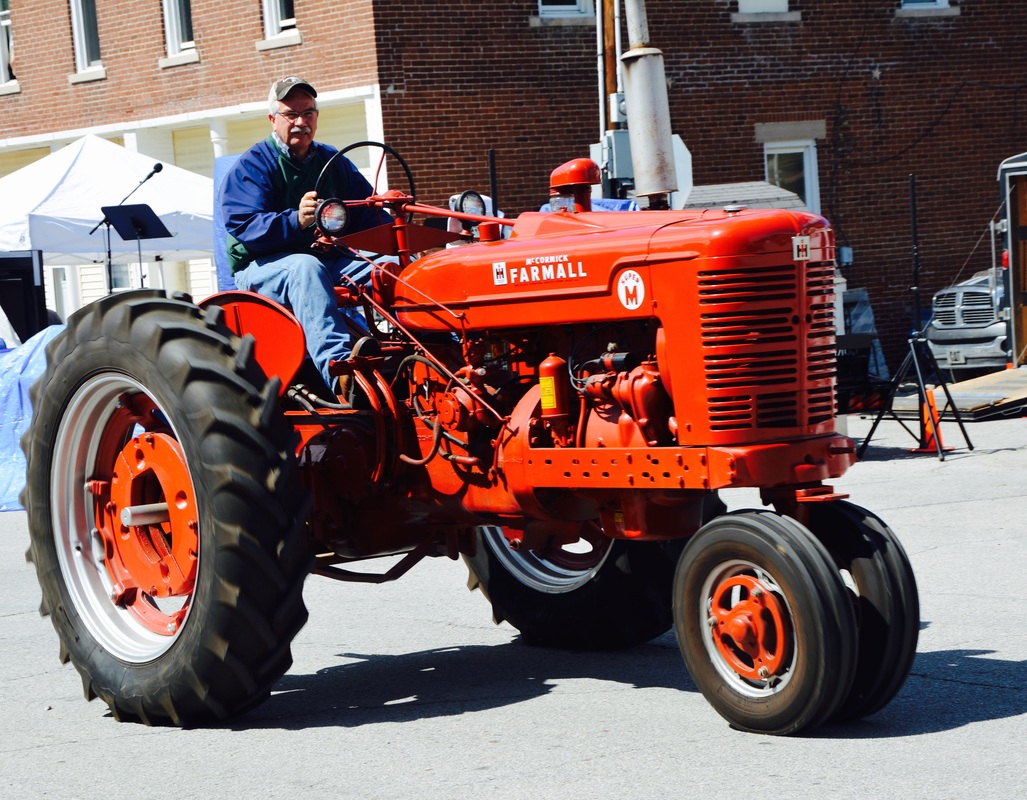 man on red tractor