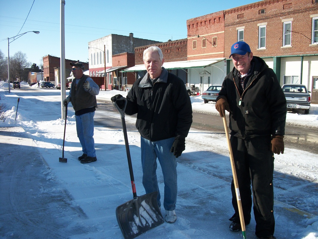 Phil Mahoy, Butch Dale, and Dick Ames clearing ice off of sidewalks. Feb 3, 2011.