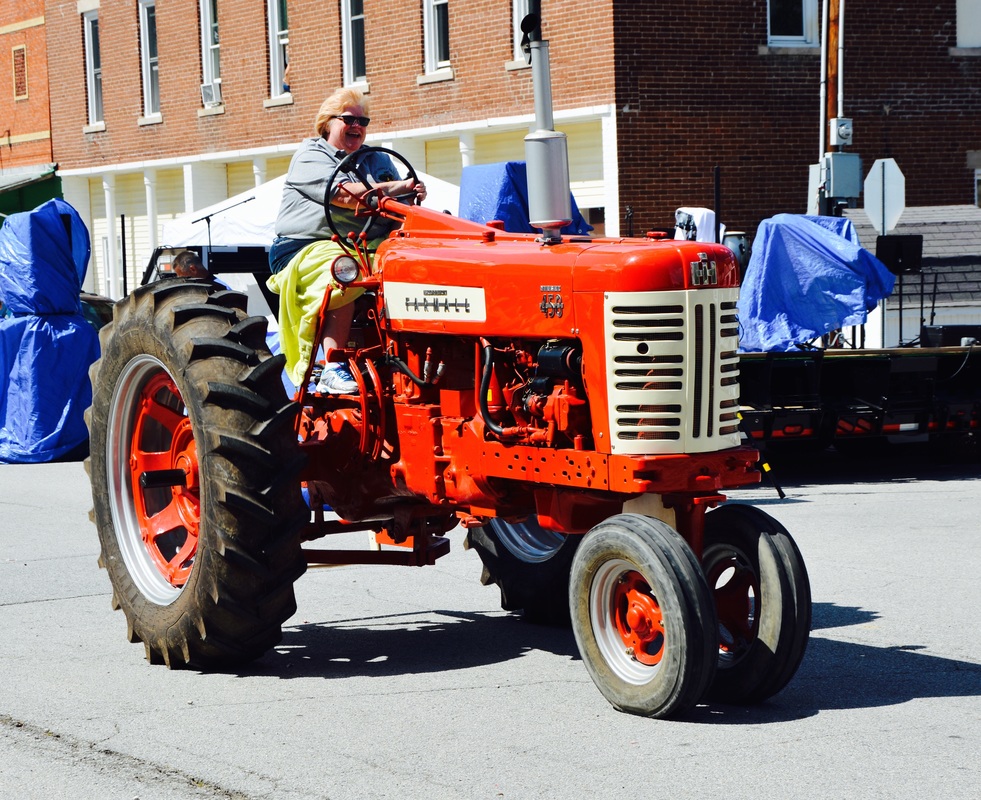 woman on red tractor