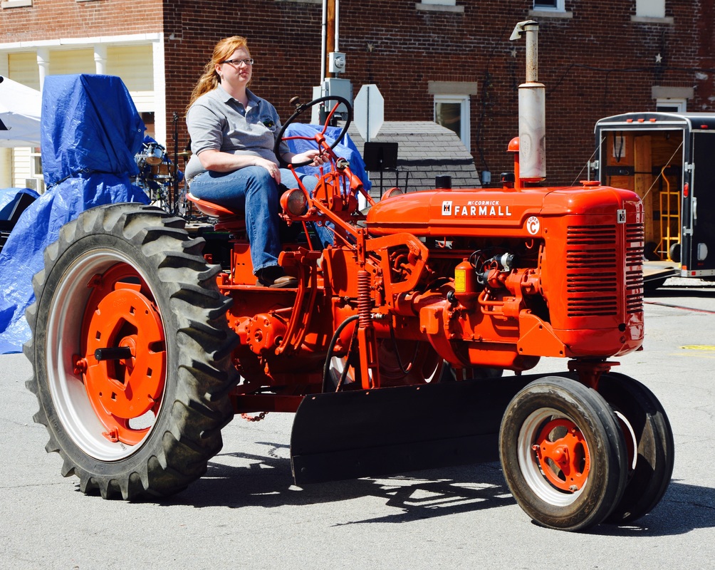 woman on red tractor