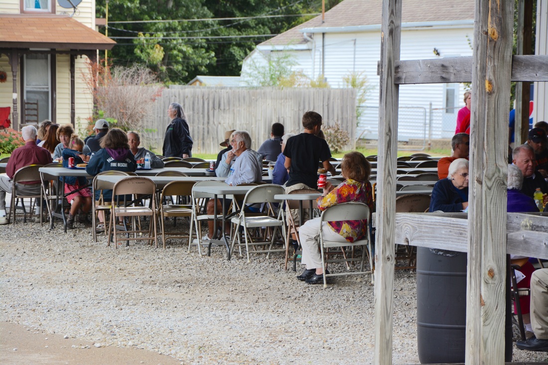 people sitting at picnic table 