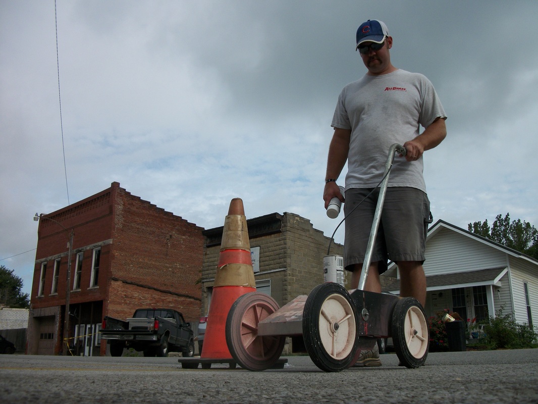 Justin Sparrow is painting parking lines on Main St. getting ready for the Fish Fry & Festival on Sept 9th and 10th, 2016.