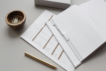 computer with gold pen 